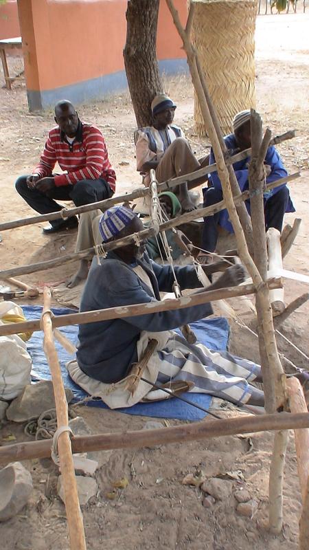 Visit of the village of Bazoulé. An old man weaves